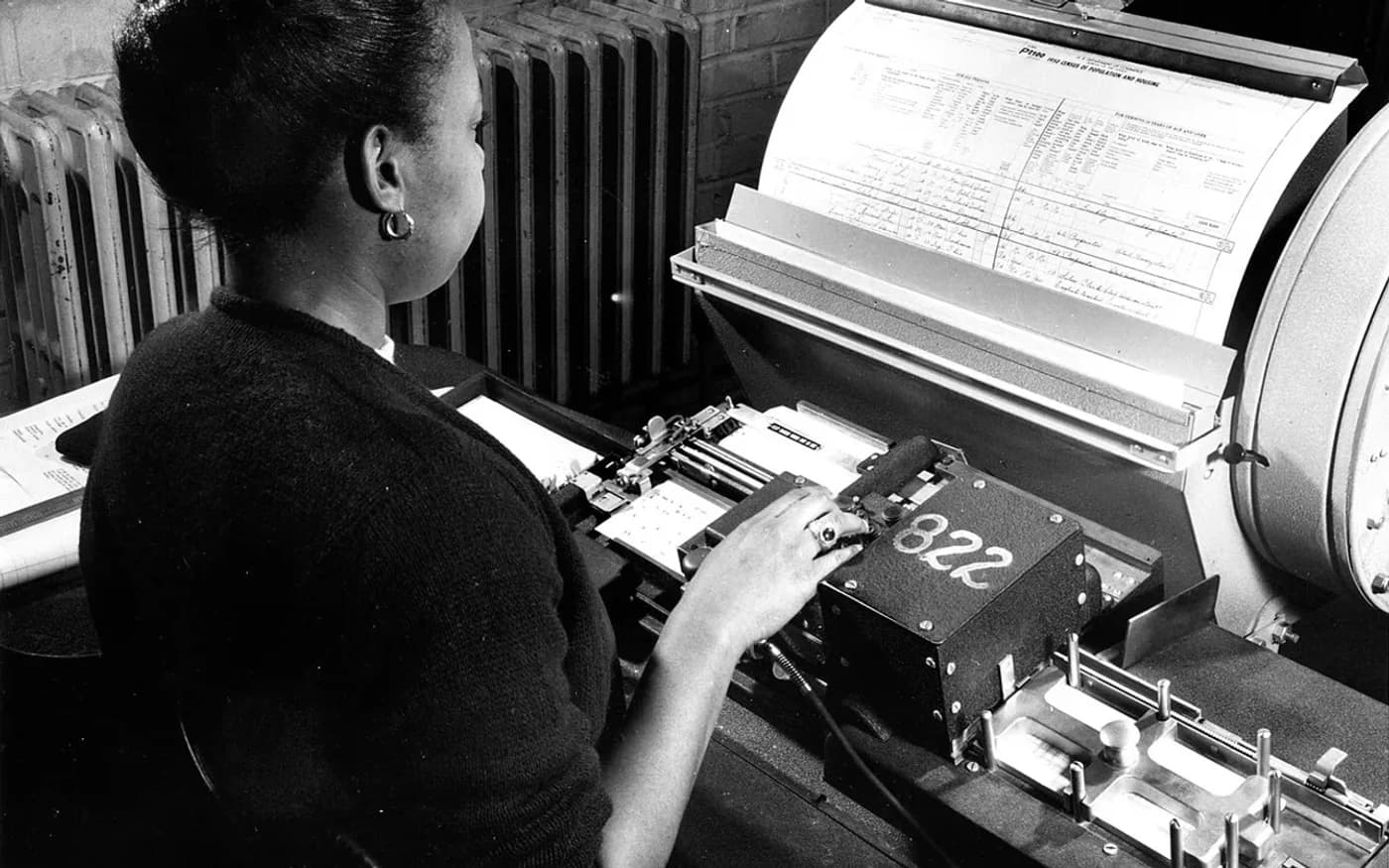 A historical punch-card or mainframe-era data processing scene.